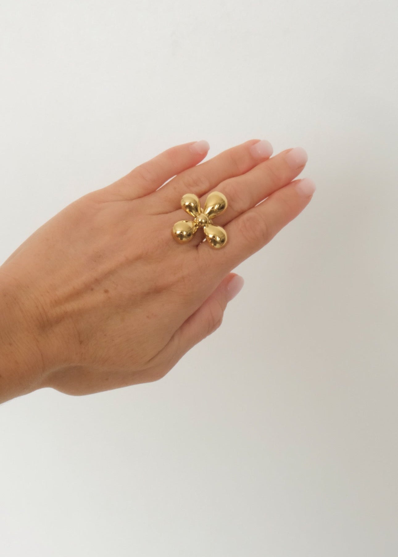 Bague argentée en acier inoxydable avec boule sculptée en forme de fleur, design délicat et élégant.