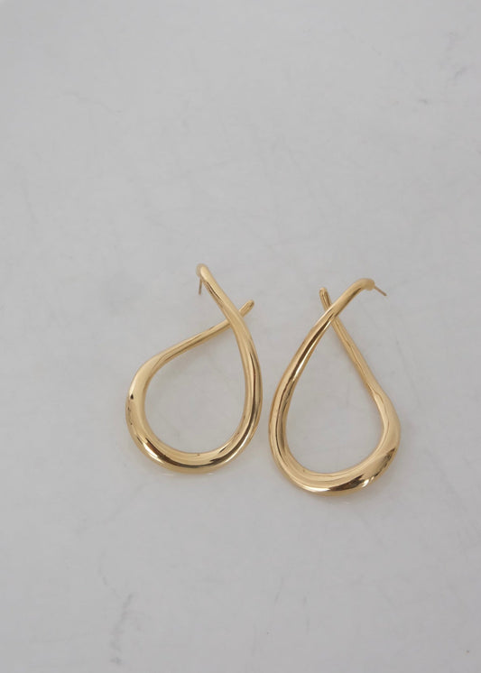 Boucles d’oreilles dorées en acier inoxydable en forme abstraite, avec fermoir puce, au design moderne et lumineux.